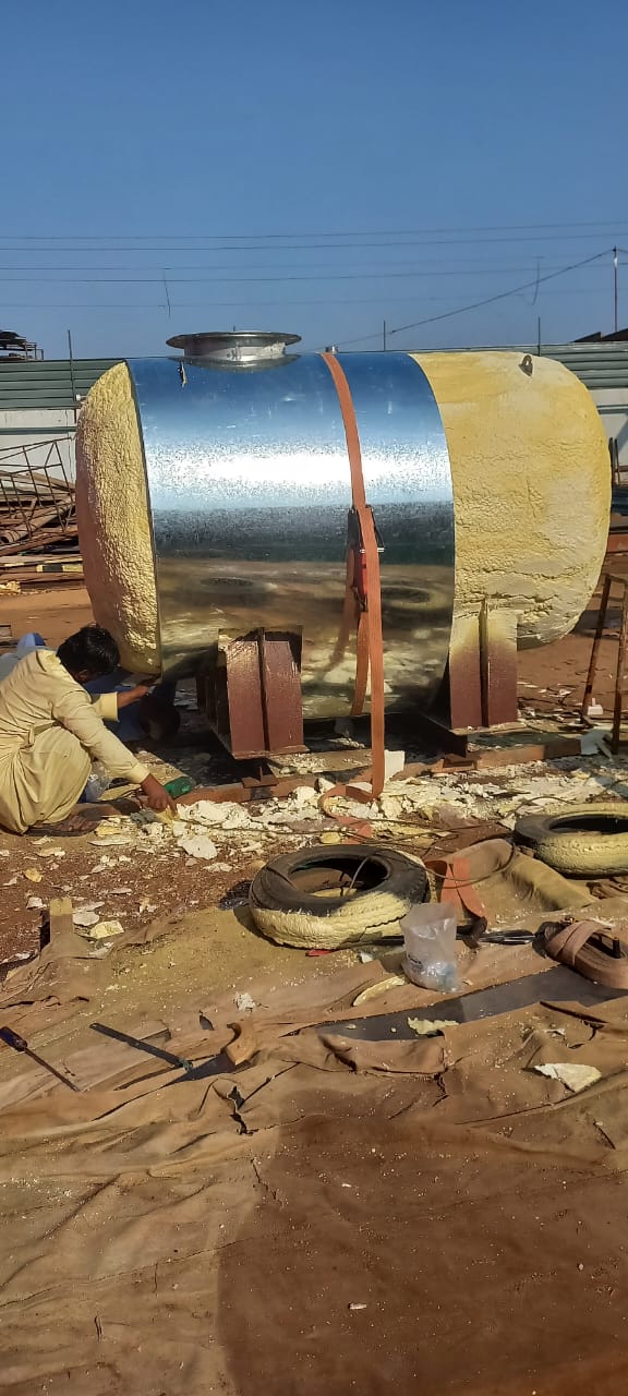 Metal cladding installation over an insulated industrial tank