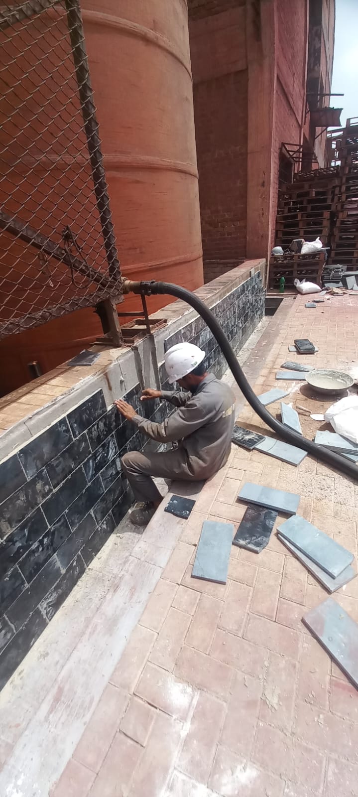Acid proof tiles being installed in an industrial facility